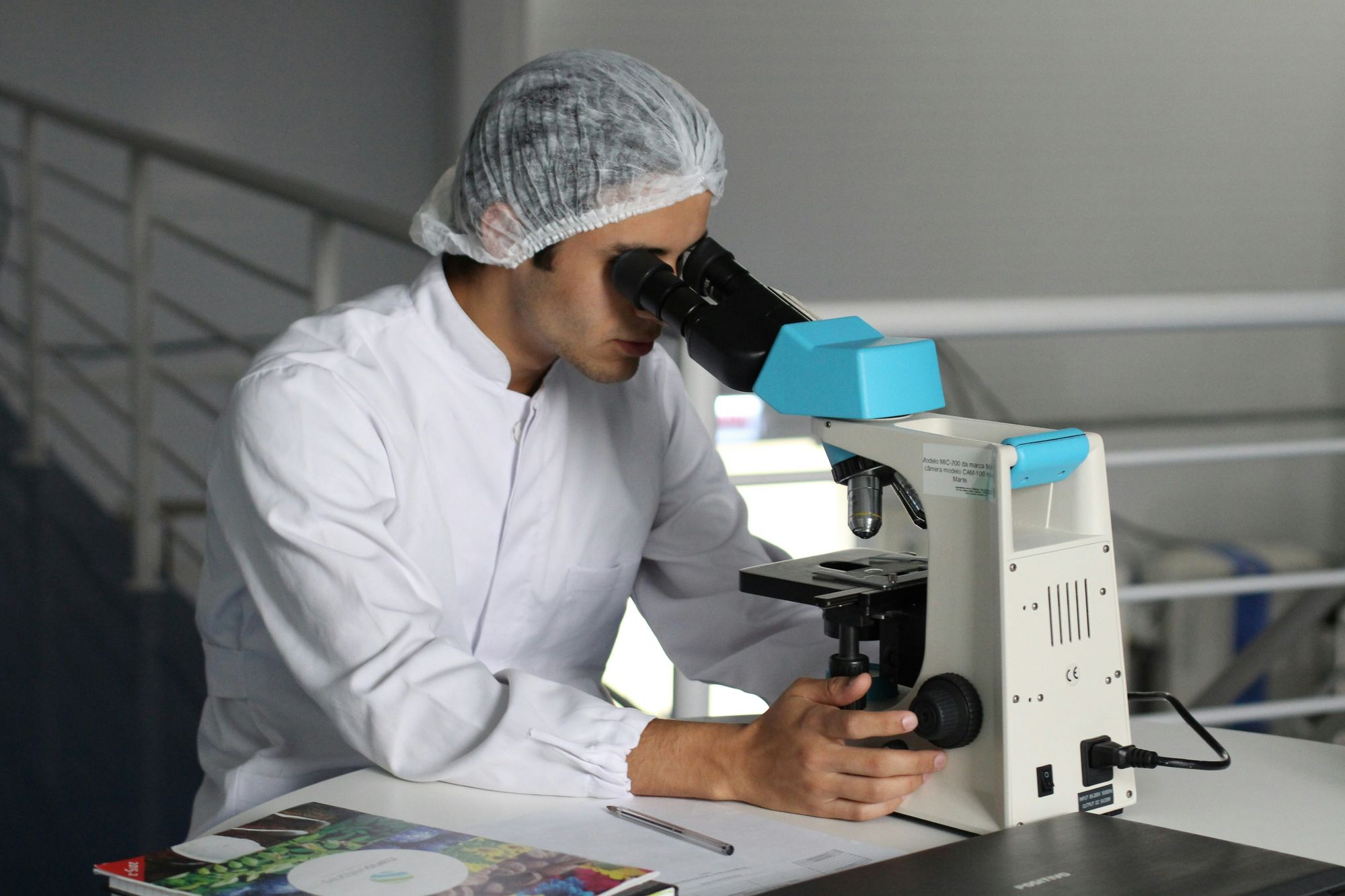 Medical professional with Dr. Susan Baker MD performing Genetic Cancer Testing with Ambry in a sterilized lab.