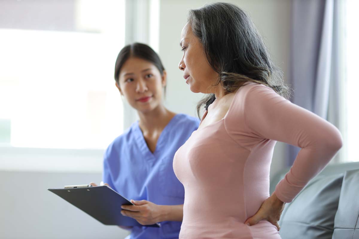 Team member at Dr. Susan Baker MD providing a comprehensive clinical consultation for lower back pain at her Beverly Hills office.