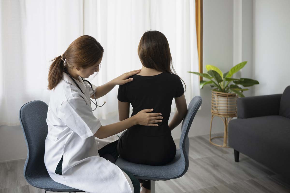 Dr. Susan Baker MD evaluating a patient baseline to address chronic back pain at her Beverly Hills medical practice.