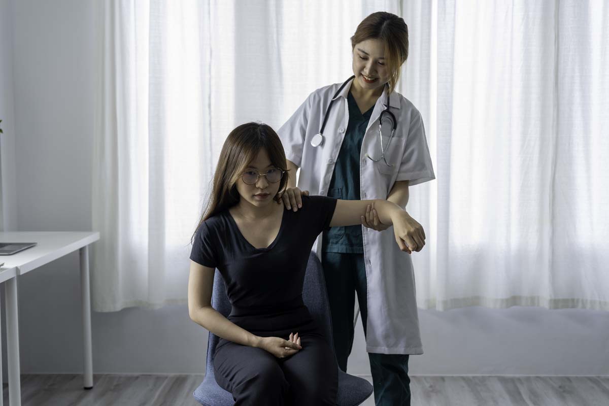 Doctor with Dr. Susan Baker MD evaluating advanced spinal and joint diagnostics for ankylosing spondylitis at Beverly Hills office.